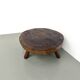 Brutalist coffee table in solid teak, monolithic slab, tripod base.