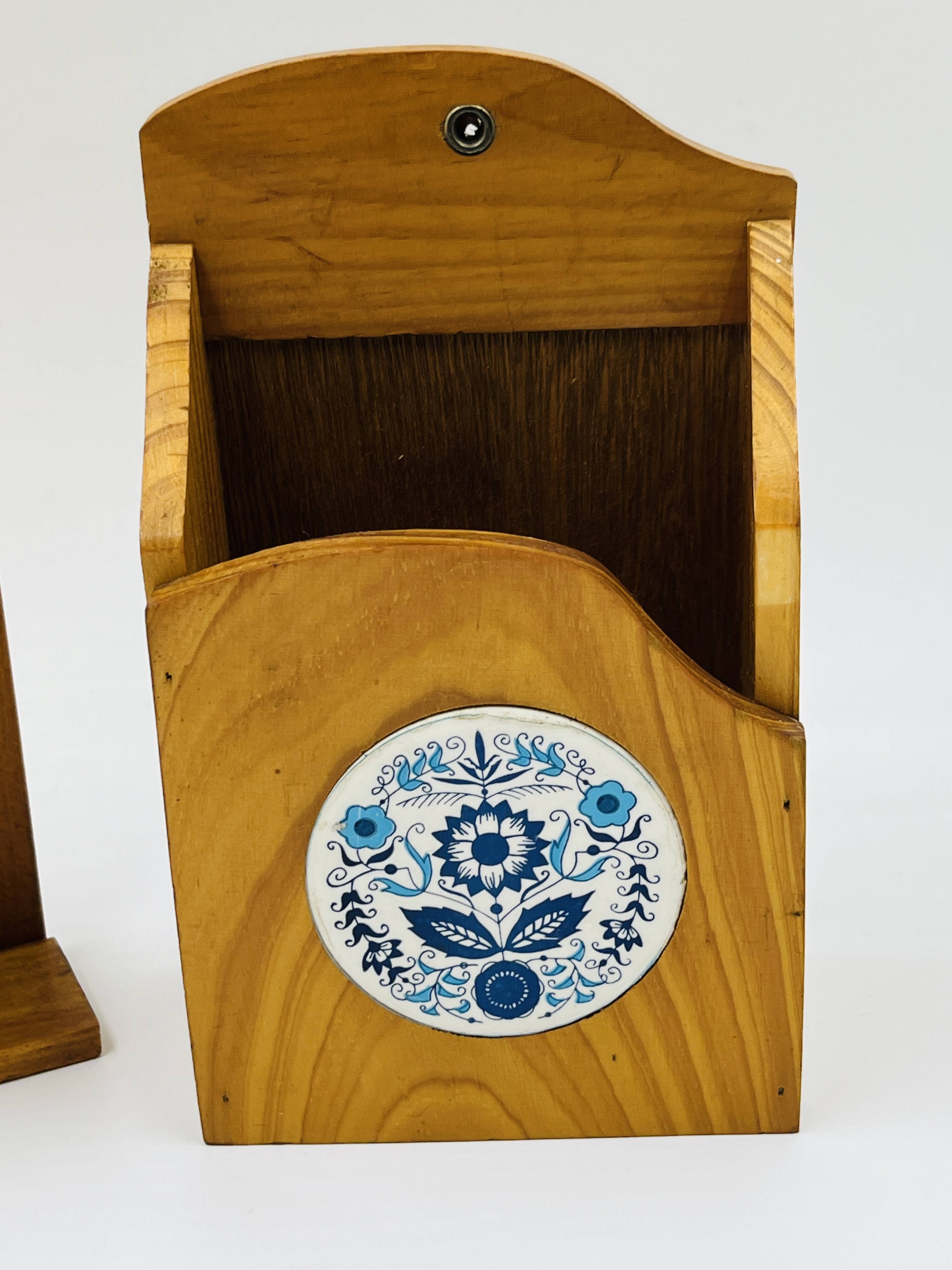 Wall-mounted egg cup holder and wooden utensil holder.