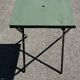 Folding garden or bistro table in khaki sheet metal from the early 1950s.