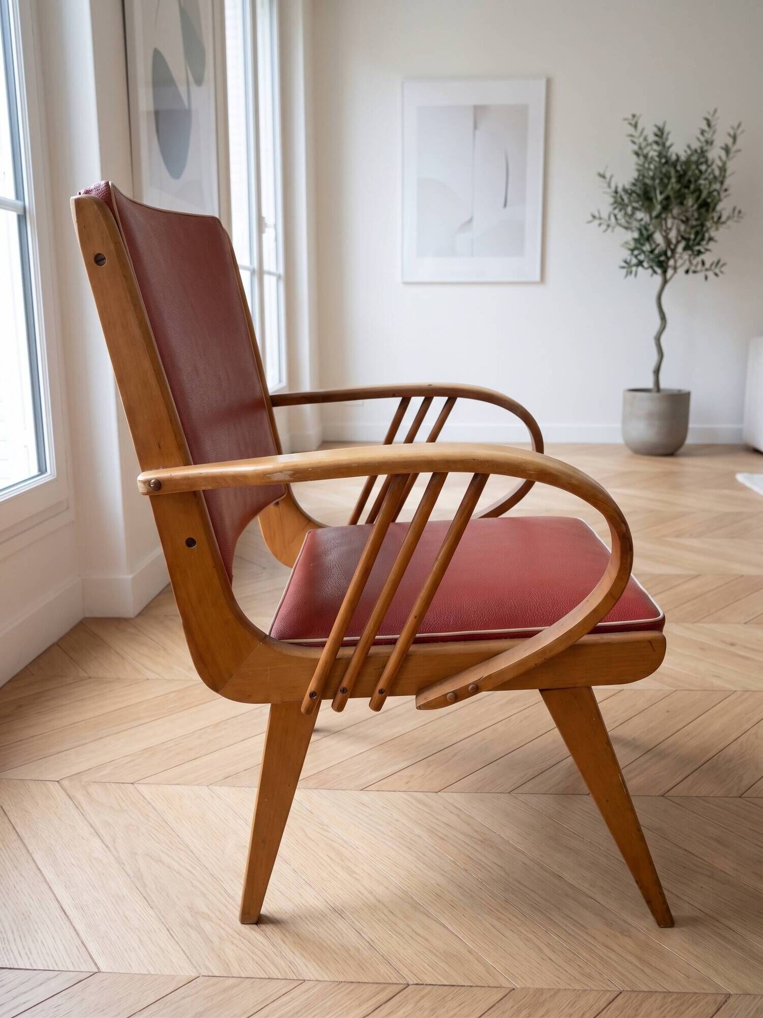 Vintage 1950s armchair in wood and red faux leather.
