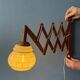 Vintage wall lamp with teak wood scissors and glass shade.