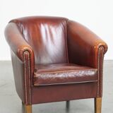 Comfortable, rugged cognac-colored sheepskin club armchair with a characteristic seat cushion