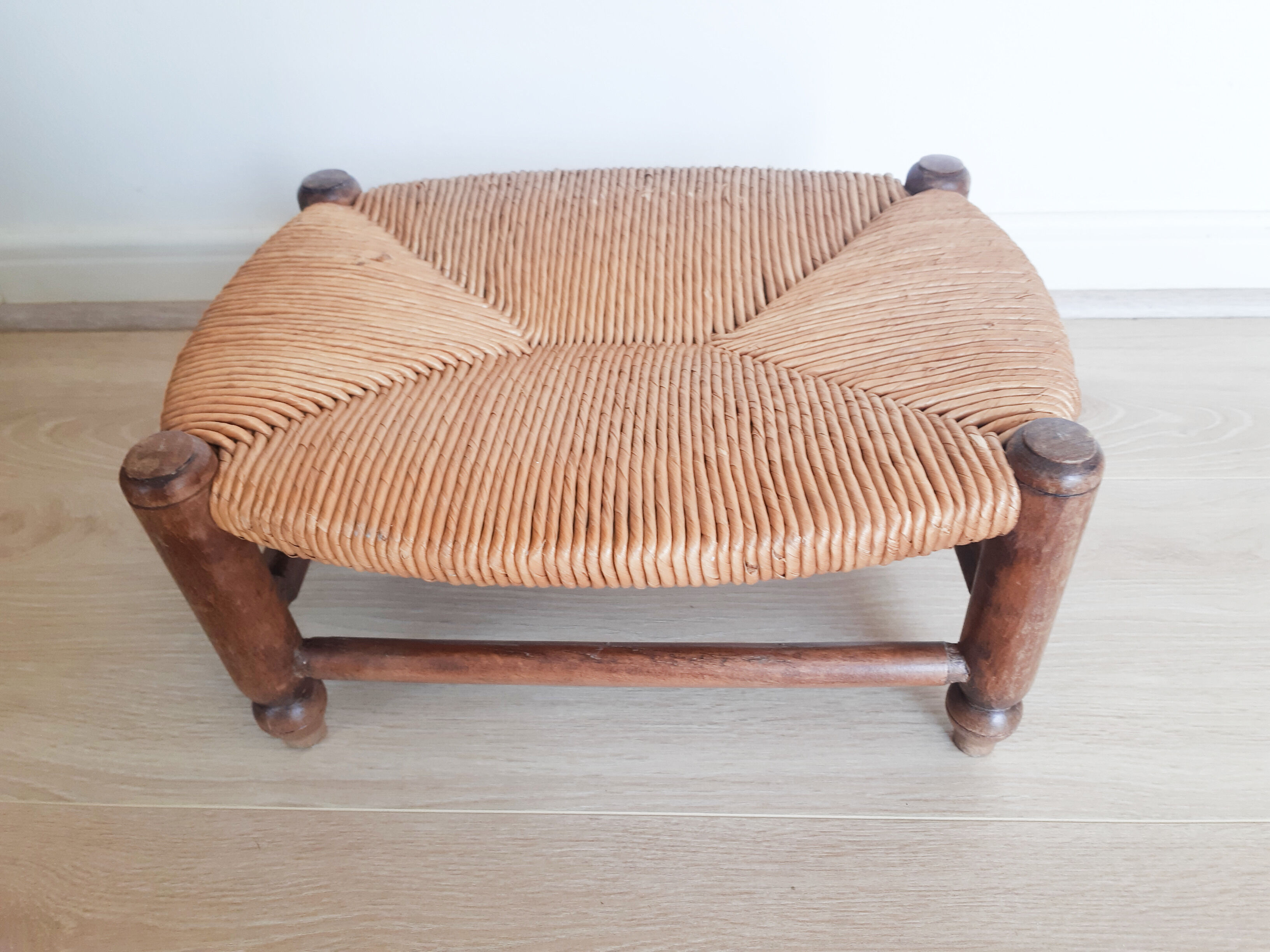 Low wooden stool and straw