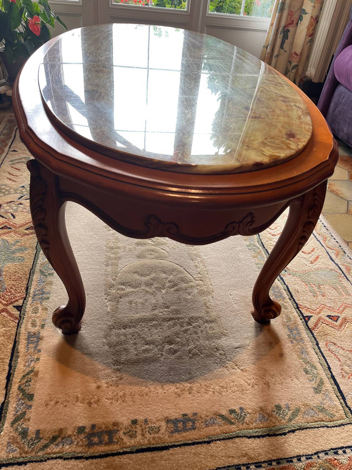 Oval marble and solid wood coffee table