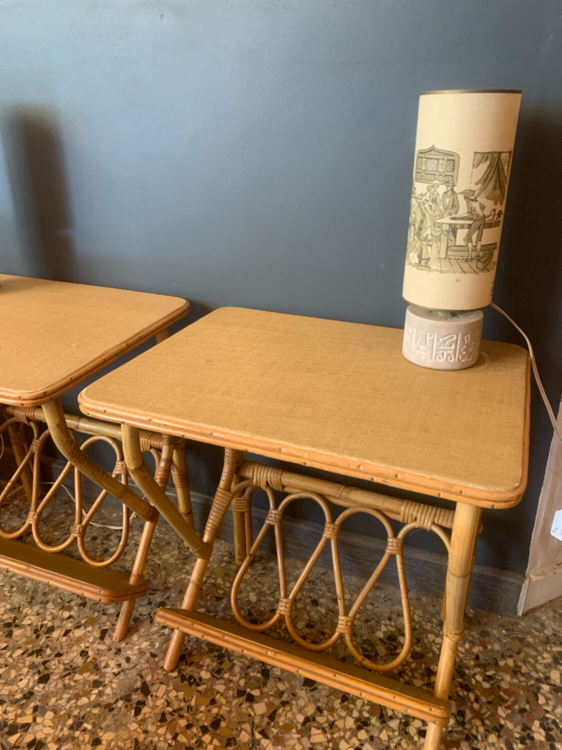 A pair of rattan bedside tables.