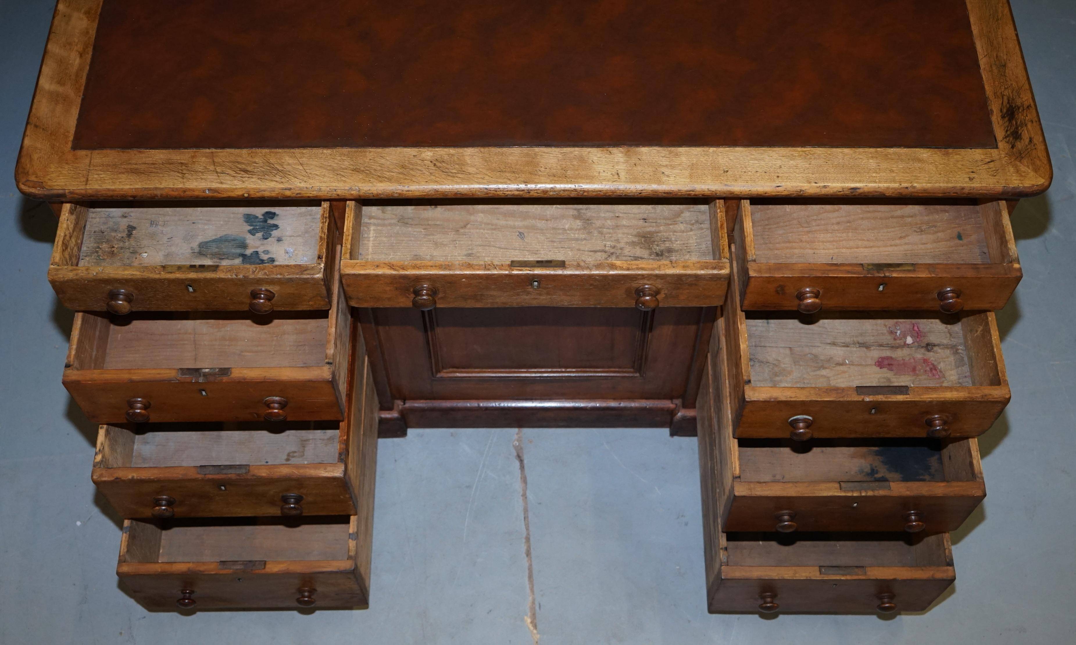 Antique Victorian oak kneehole desk with 18 double-sided drawers.