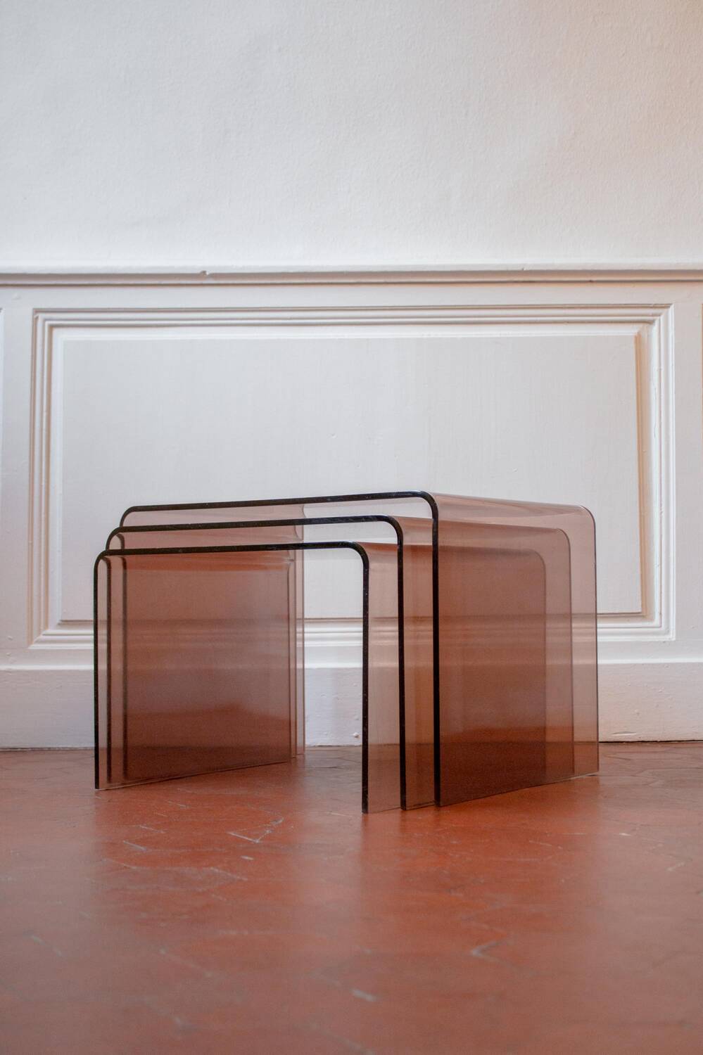 Vintage trio of nesting tables in smoked plexiglass by Michel Dumas, year.
