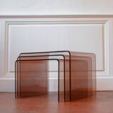 Vintage trio of nesting tables in smoked plexiglass by Michel Dumas, year.