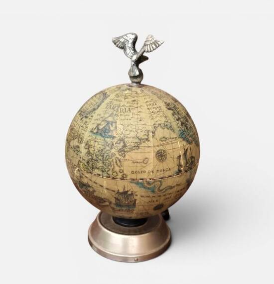 Vintage globe bar service with its liqueur bottle.