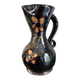 Black vase with yellow flowers