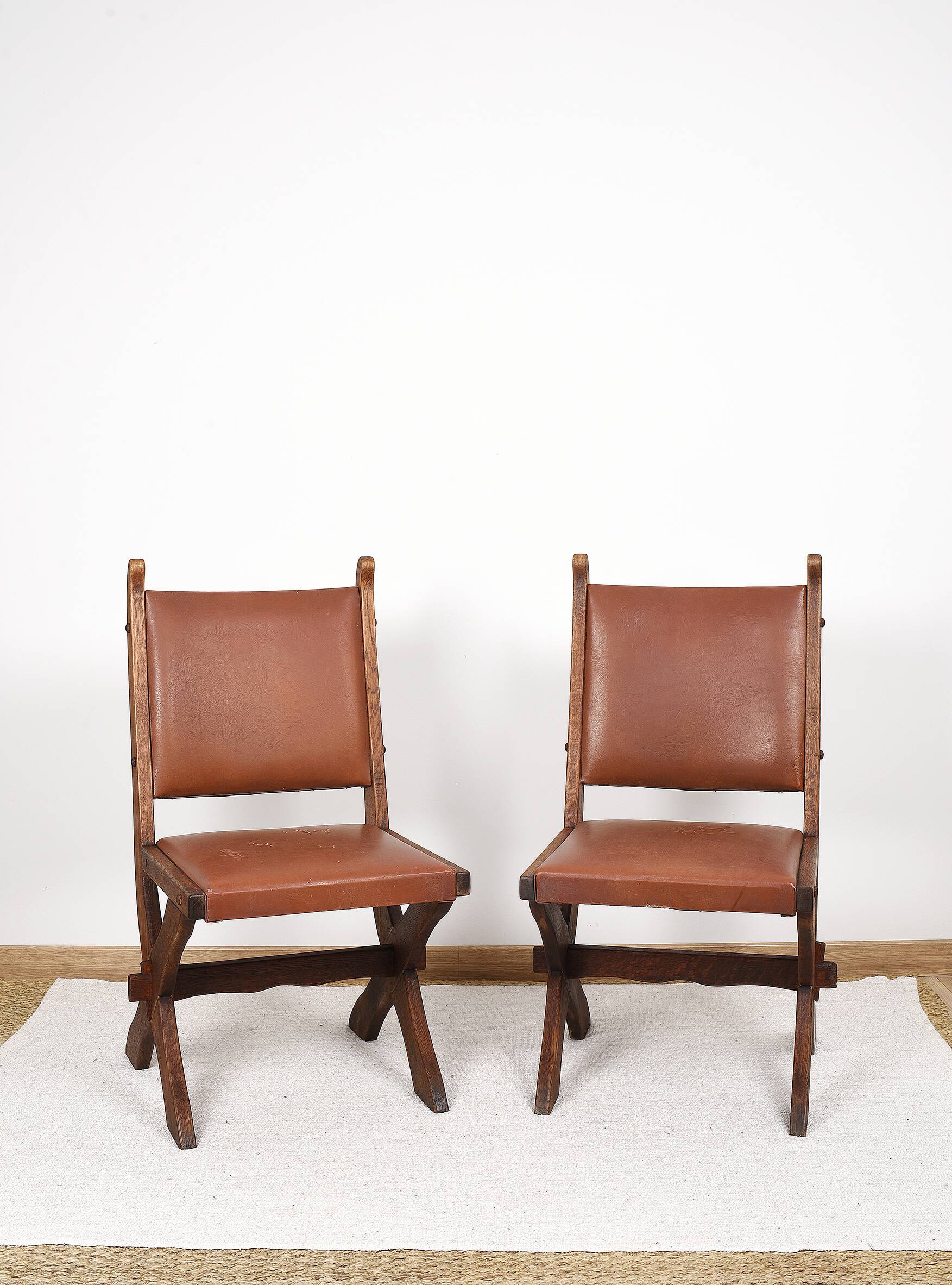 Pair of brutalist style chairs, in wood and leather.