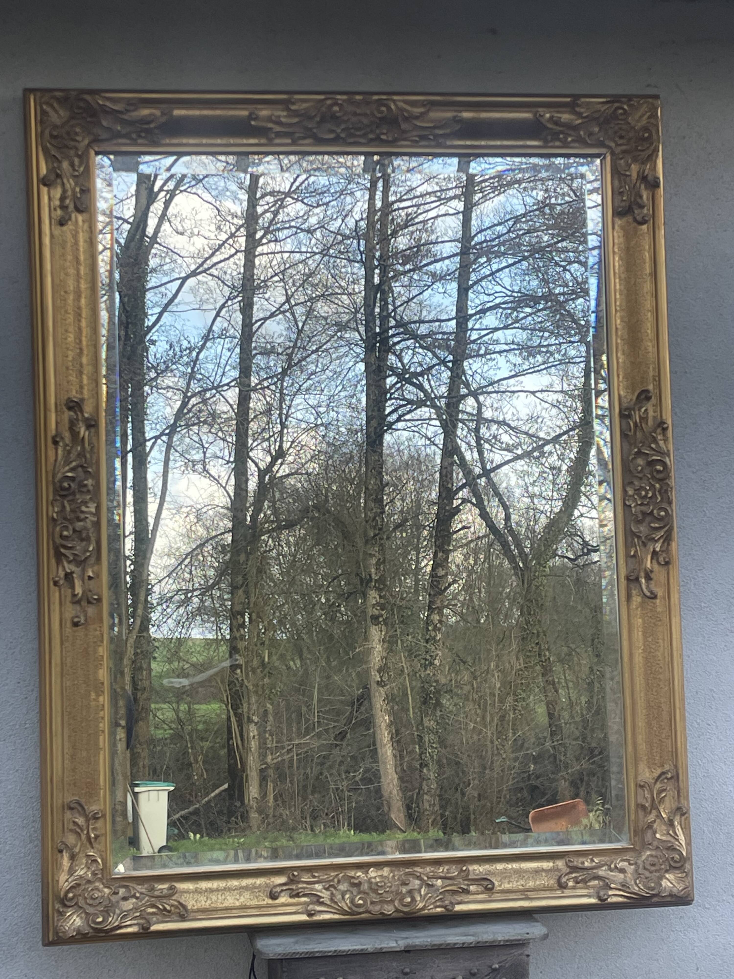 vintage bevelled mirror in rectangular shape, stucco and gilded wood in Louis XV baroque style