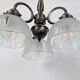 Antique Art Deco chandelier with 3 arms in patinated metal and ribbed glass.
