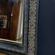 19th-century mirror Napoleon III in blackened wood on a gold background.