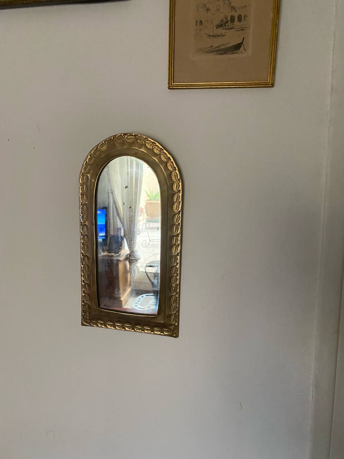 Ethnic brass mirror crafted in the 1980s.