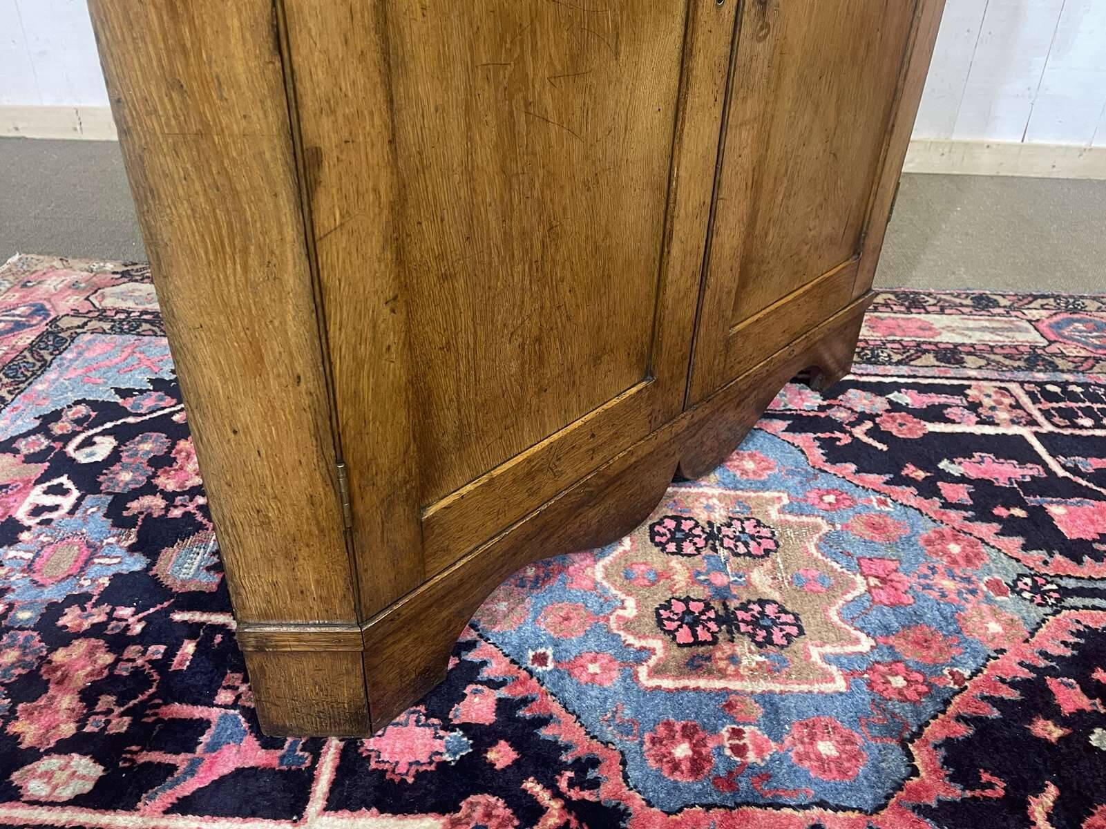 19th-century English corner cabinet in oak, mahogany, and fir.