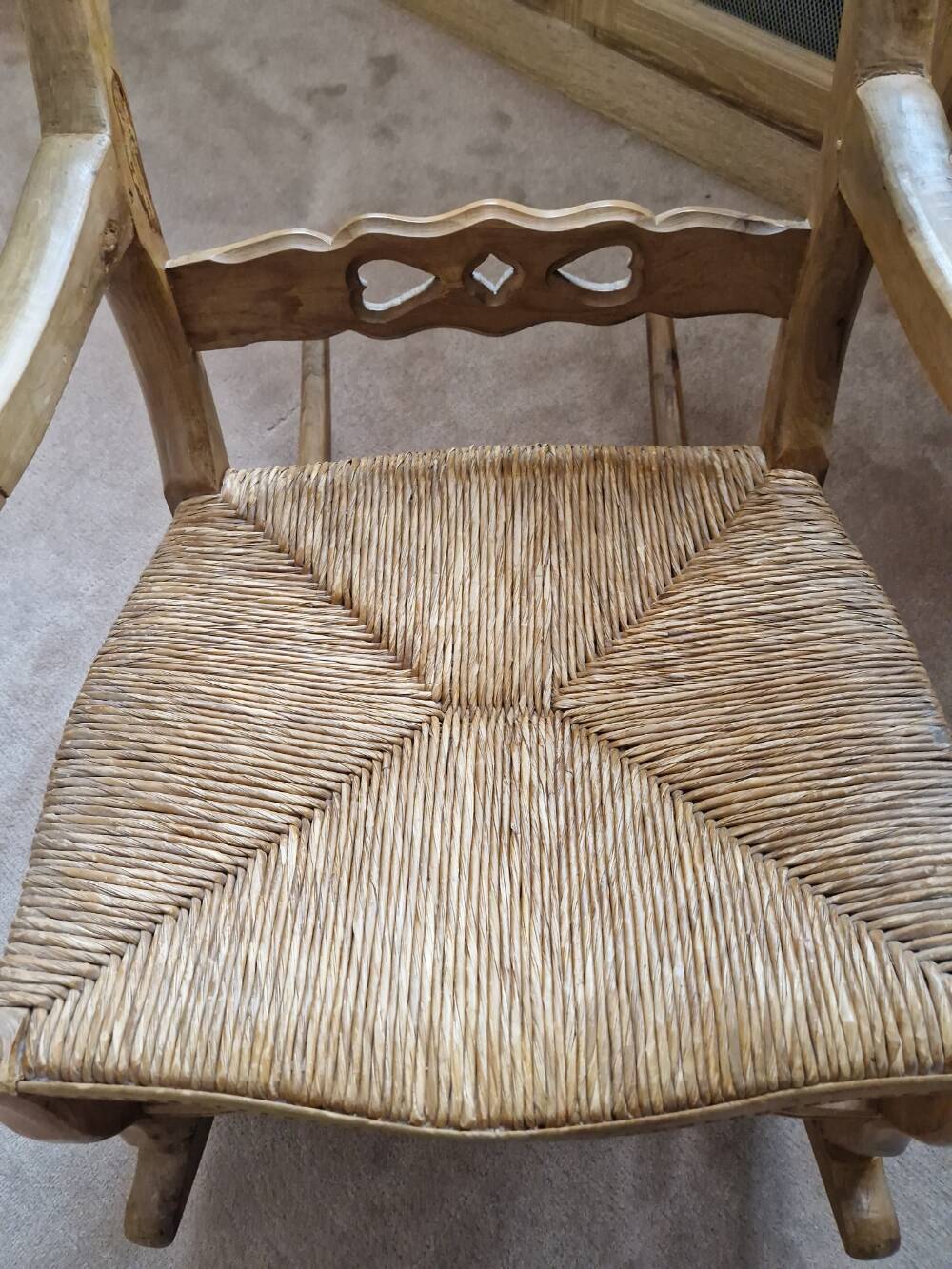 Oak rocking chair with a straw seat.