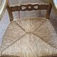 Oak rocking chair with a straw seat.
