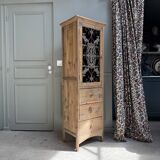 Column storage unit with a sculpted metal door.