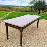 Old French farmhouse table in walnut with turned legs.