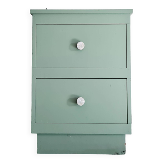 Old chest of drawers with two green drawers