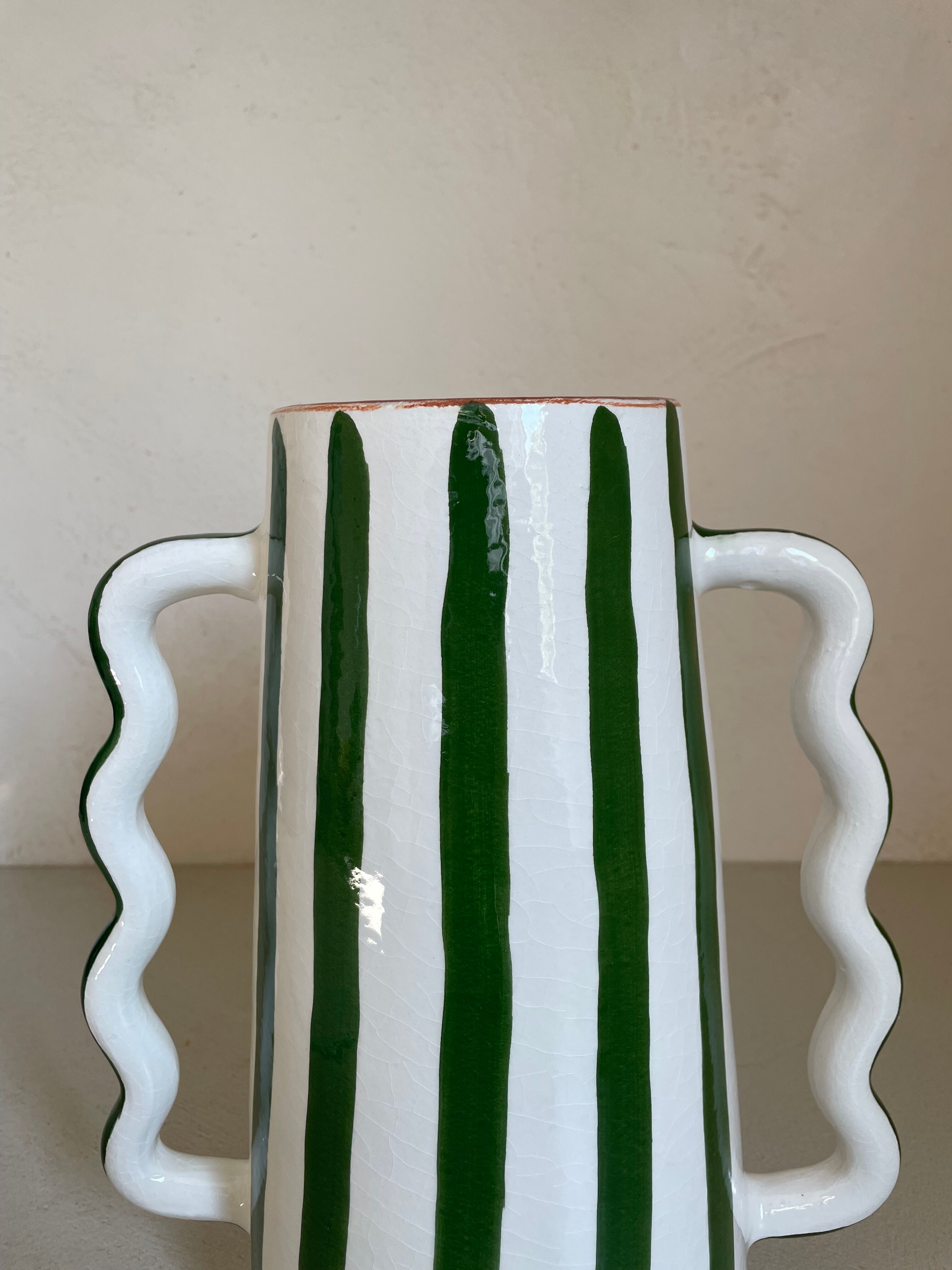 Green and white striped ceramic vase with abstract handmade corrugated handheld