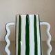 Green and white striped ceramic vase with abstract handmade corrugated handheld
