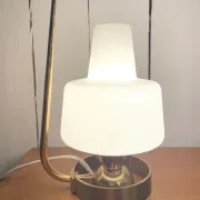 Table lamp in gold metal and opaline.