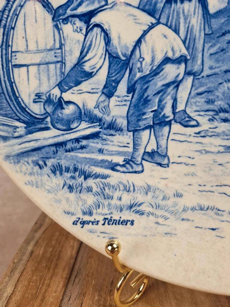 Old advertising plate with blue decoration after Teniers – 100,000 Shirts Paris