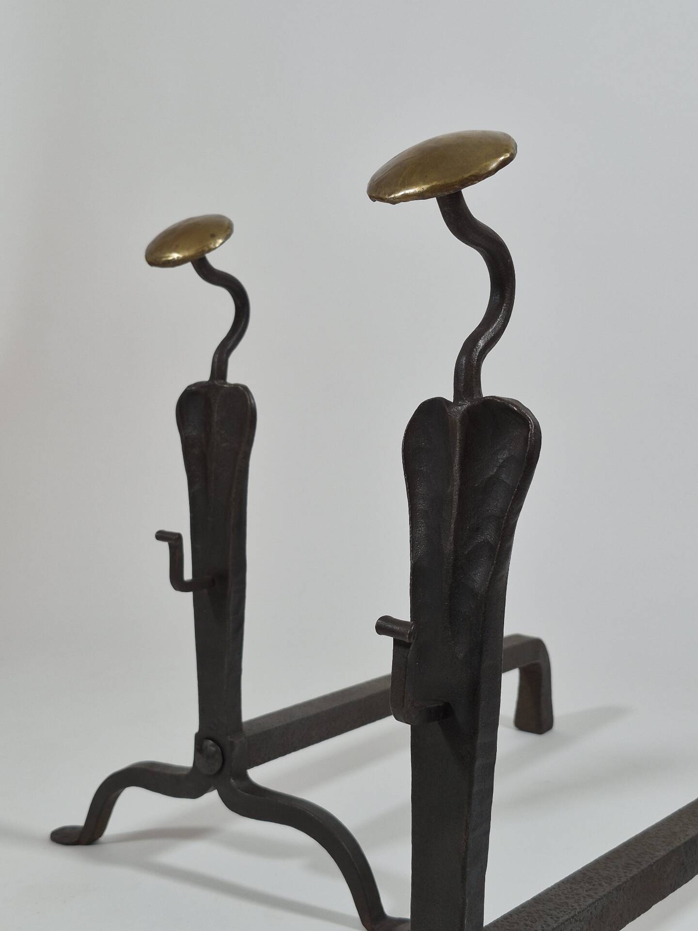 Pair of handforged metal and brass andirons