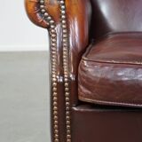 Dark English style sheepskin wingback chair with character and patina