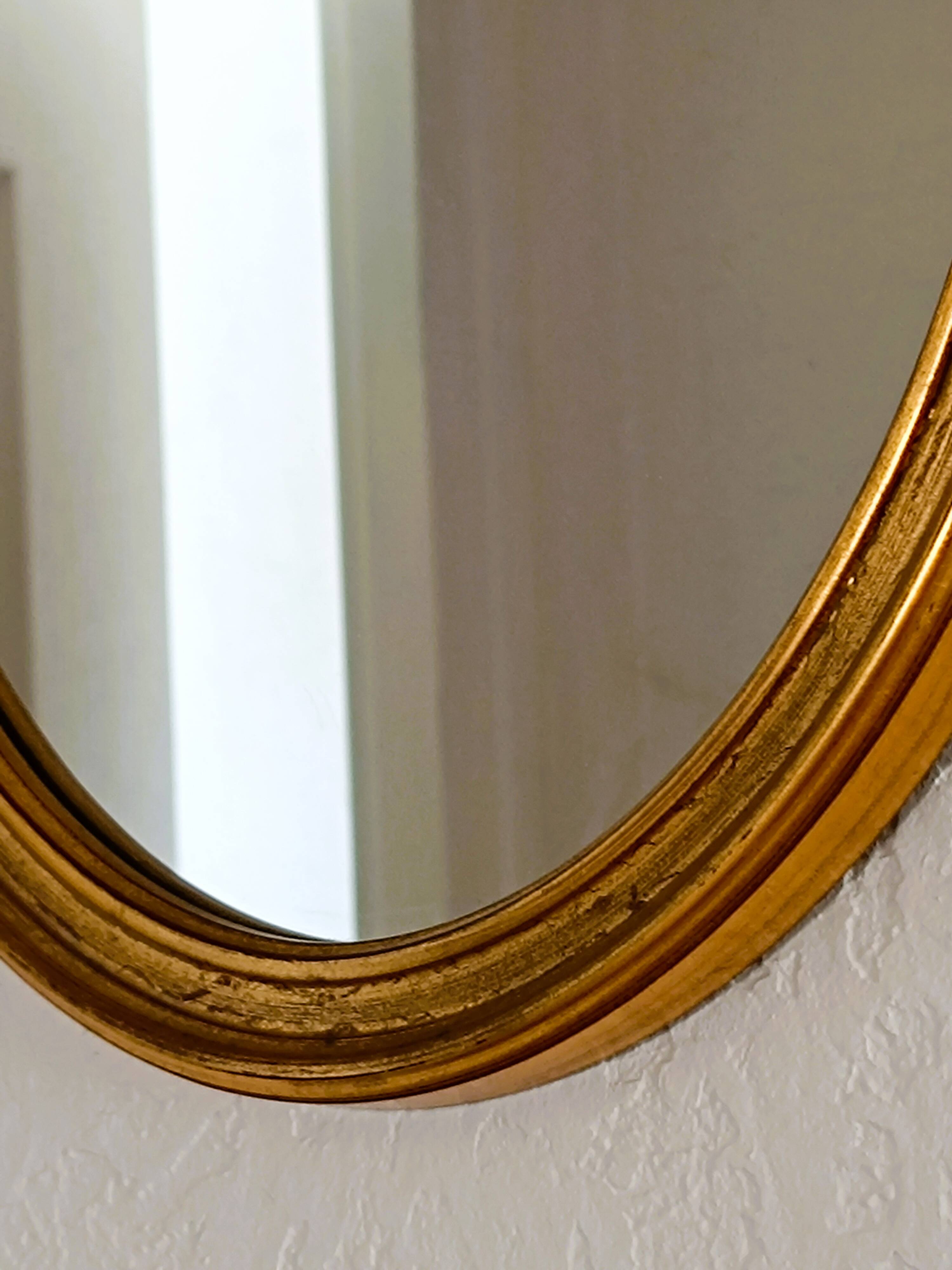 Antique oval-shaped gilded mirror
