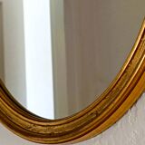 Antique oval-shaped gilded mirror