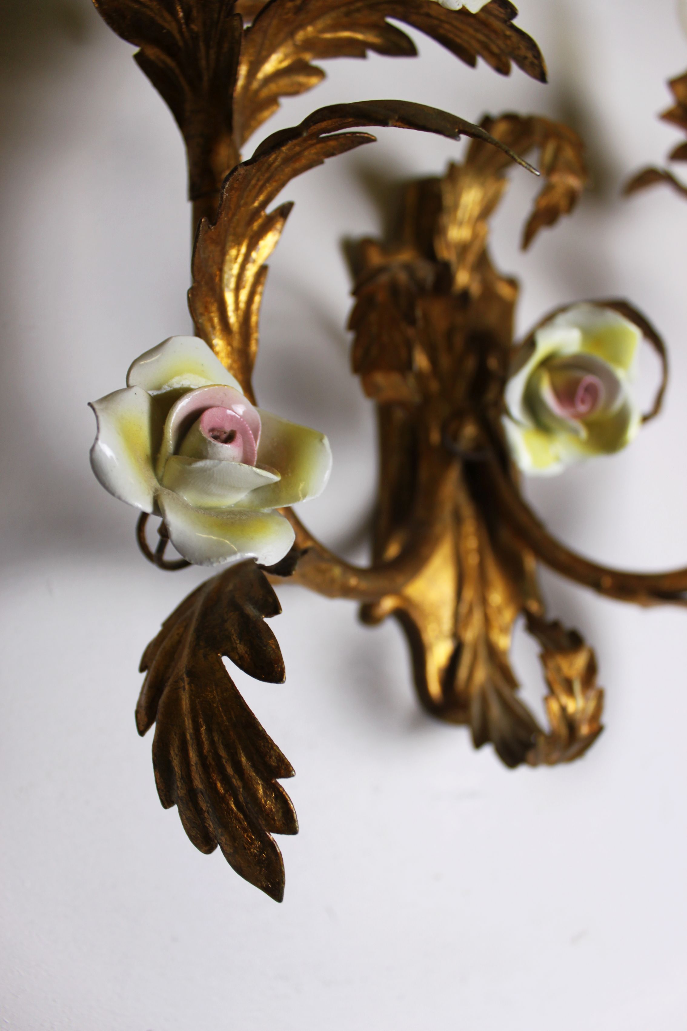 Pair of gold wall sconces with porcelain flowers