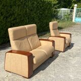 Set of vintage armchair and 2-seater sofa in beige leather and reclining wooden armrests, stressless style