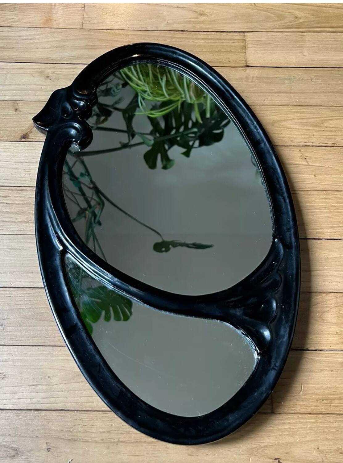 Oval cast steel mirror with Art Nouveau decor