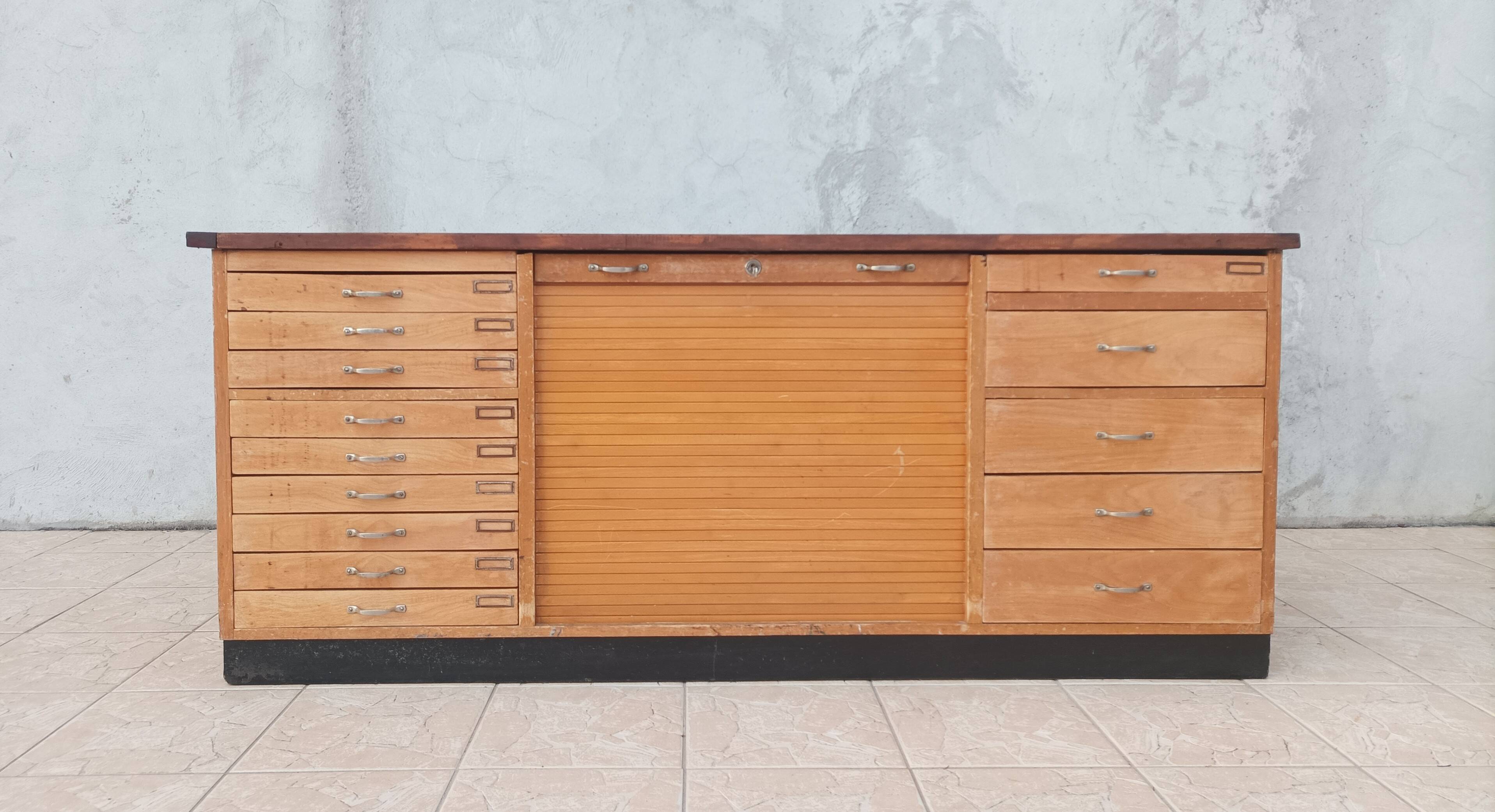 Workshop furniture with drawers and curtain in beech and walnut.