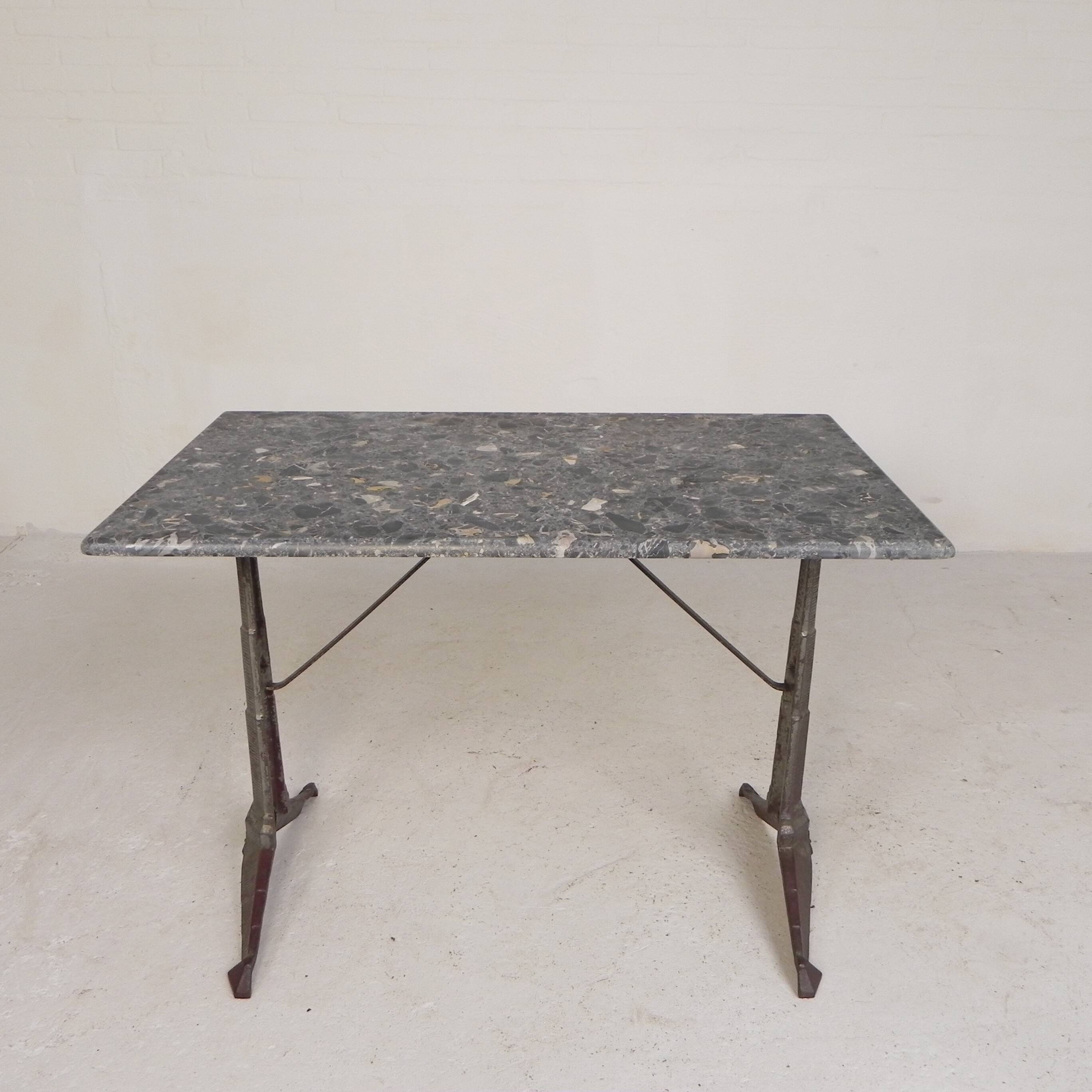Bistro table with a marble top on a cast iron frame, 1930s.