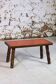 Brutalist coffee table in orange ceramic and solid wood.