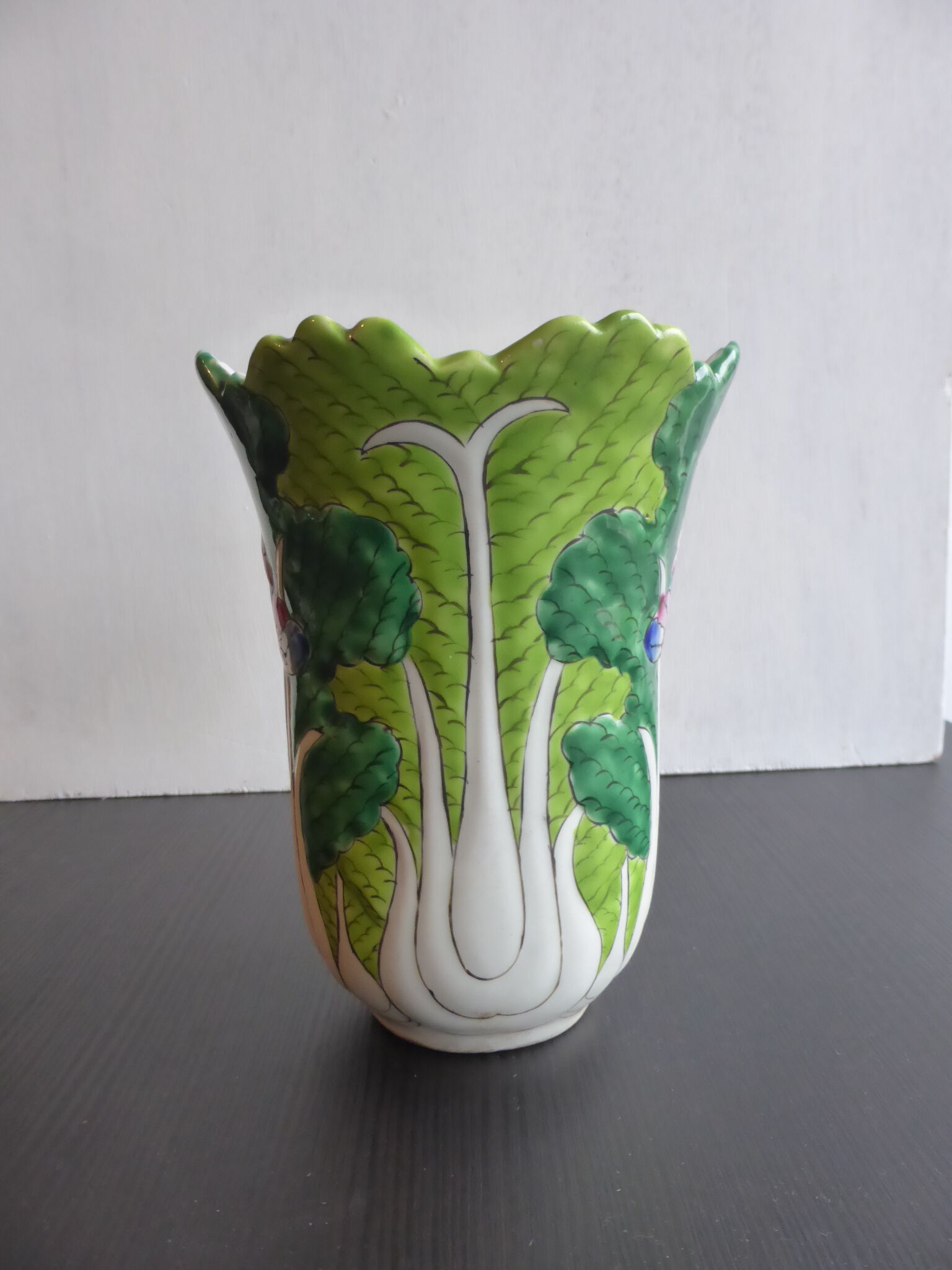 Ancient Asian ceramic vase green and white background decorated with butterflies