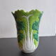 Ancient Asian ceramic vase green and white background decorated with butterflies