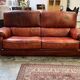 living room in patinated leather and brass from the 80s
