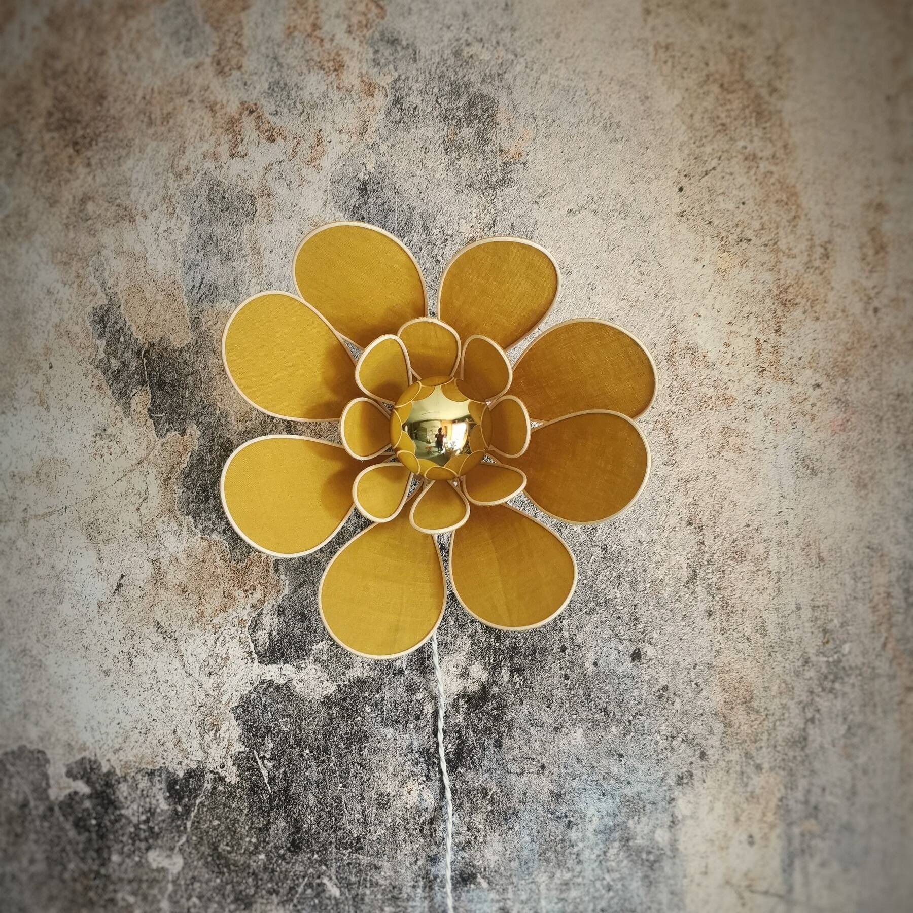 Flower wall light made of rattan and saffron linen petals