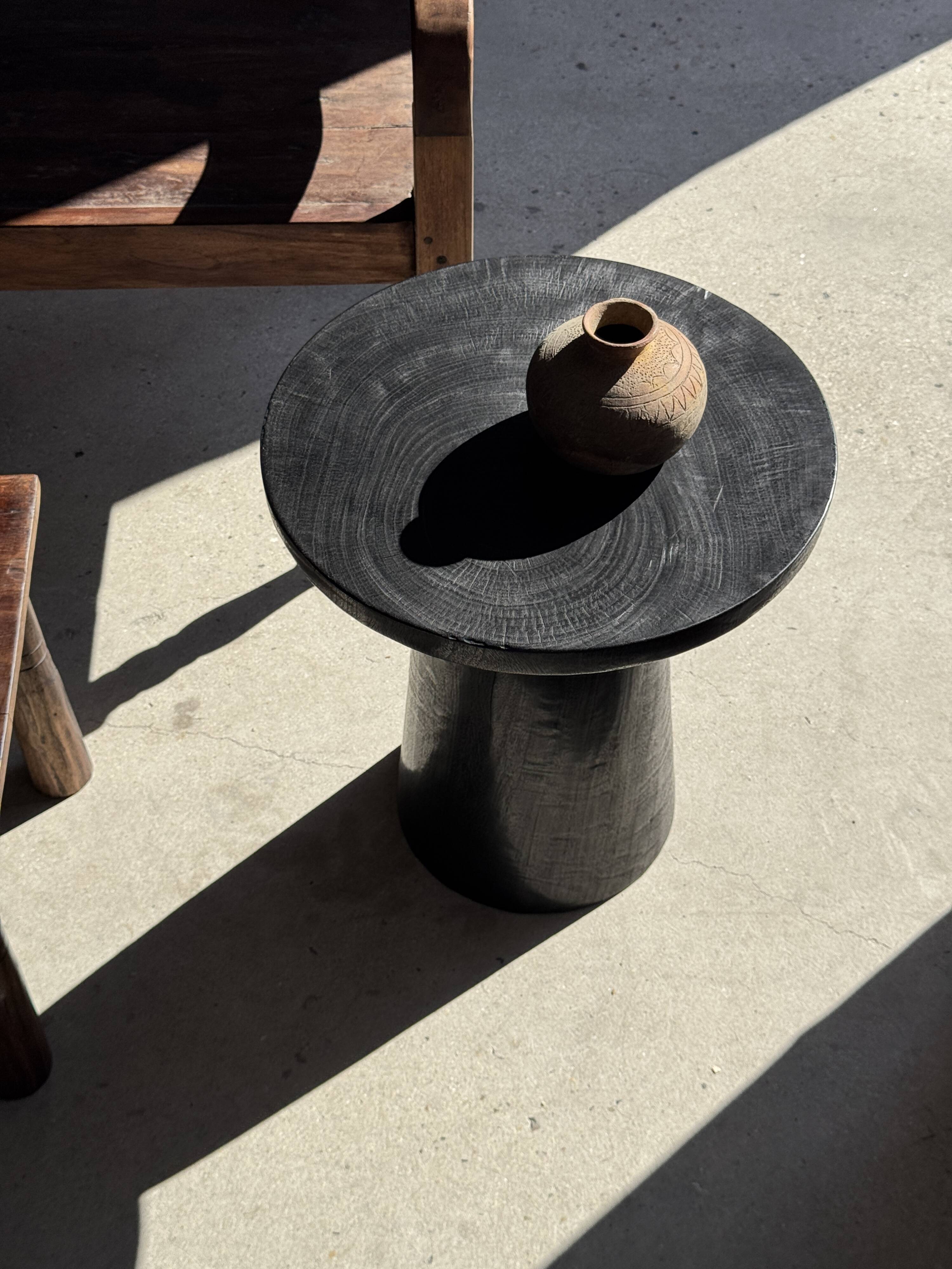 Black solid mango side table (monoxyle) with conical legs