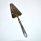 Antique silver-plated pie server with a brass blade decorated with roses.