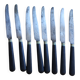 A set of 8 knives with black wooden handles and bolsters.