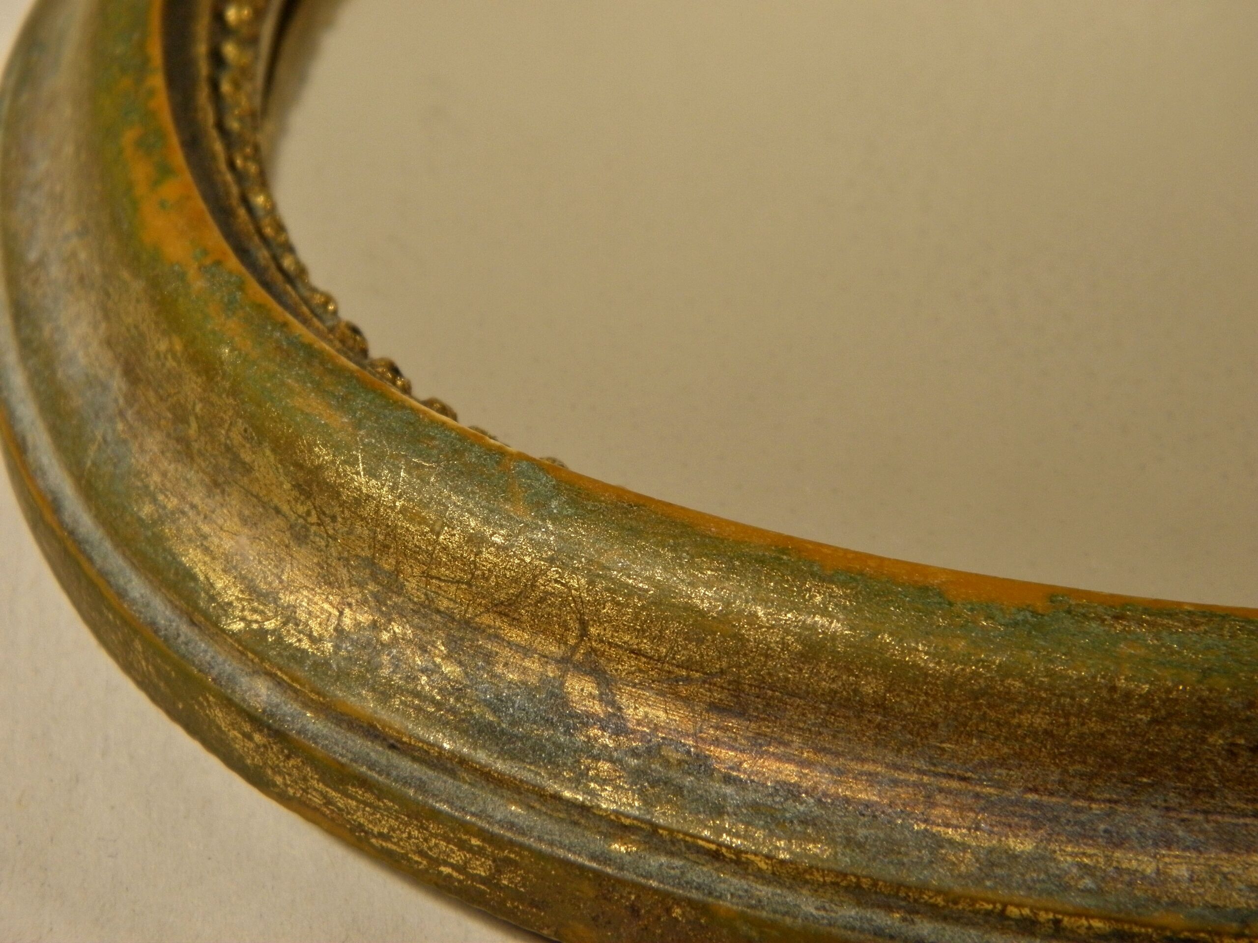 Golden oval mirror