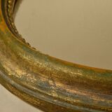 Golden oval mirror