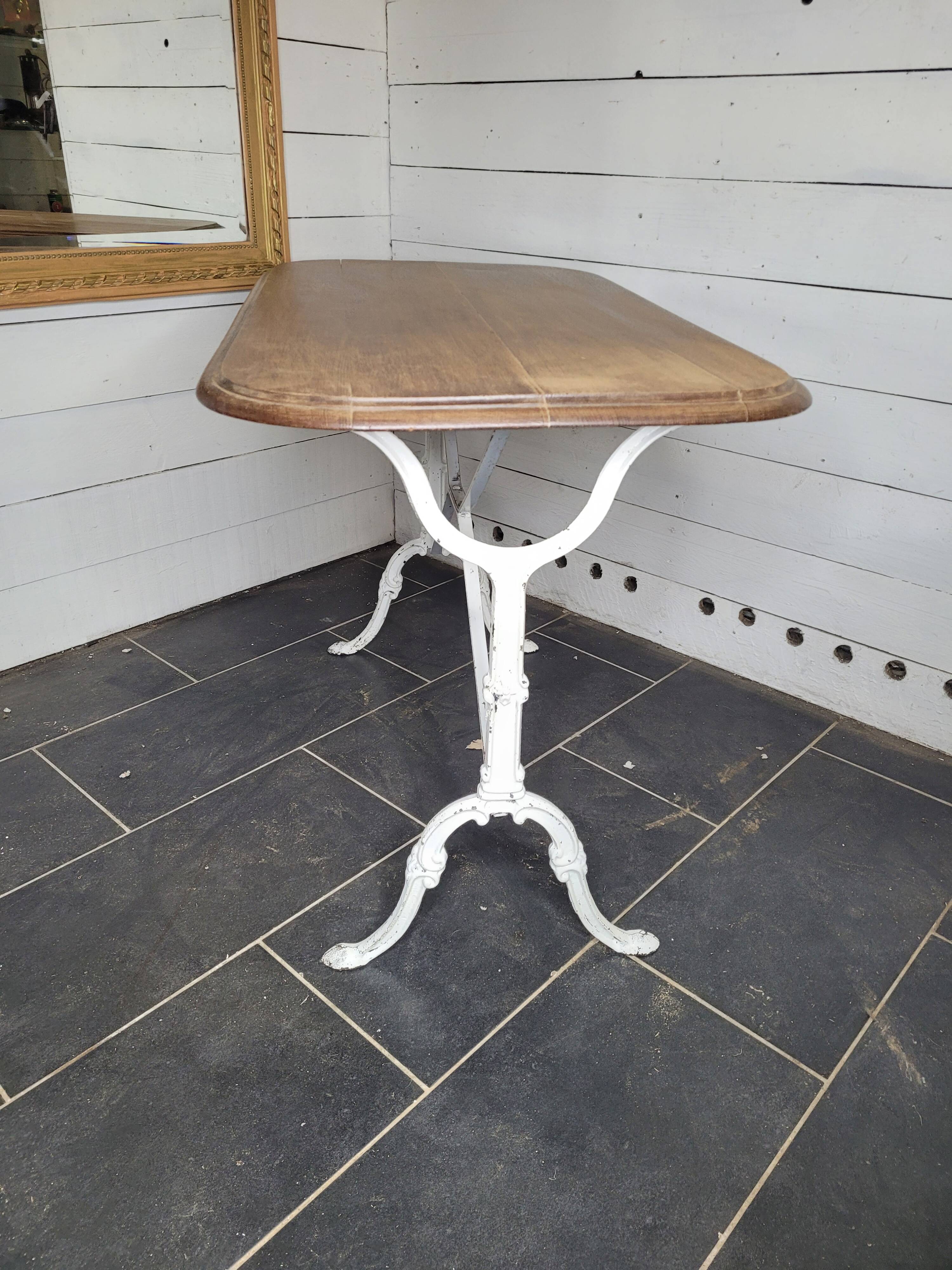 Bistro table with cast iron base and oak top
