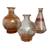 Trio of pink bottle decanters